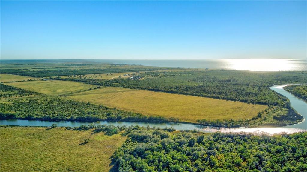 TBD Gau Road Double Bayou, Texas Nestled on the East fork of Double Bayou, with approximately 1,118.94 feet, at North boundary, of waterfront! One-of-a-kind tributary that flows to Trinity Bay allowing the best fishing with its brackish water! Just wait until you take a boat ride along the bayou and even out to the open water of the bay! Irrigation ditch runs through the middle of the property and can be accessed to water each with proper ditches depending on the field you intend to irrigate. Fenced and cross fenced with road access to each pasture. A 30'X60' barn is on site with working cattle pens and squeeze chute. Electrical lines available to majority of ranch. Unrestricted and ag exempt! Please refer to MLS# 31988291 for additional 57+/- acres, with bayview, that touches this property! Seller will consider selling canal front bay house, at additional cost, that is across from the 57 acres and included in the HOA of Bayou Estates that allows access to the pier and boat ramp.