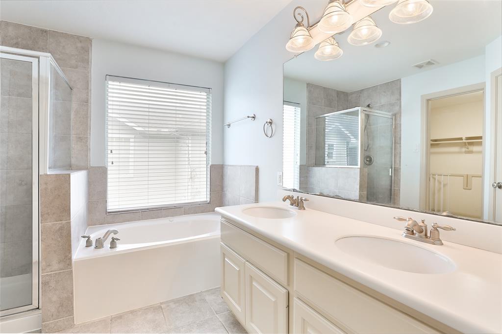 Light and bright primary bathroom with double sinks.