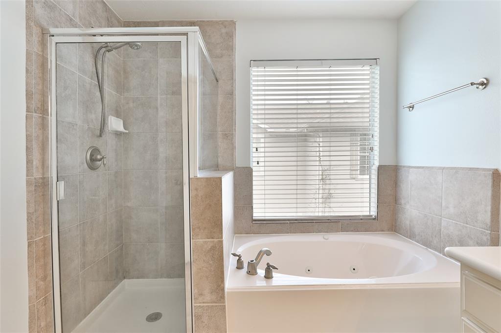 Primary bath includes a garden tub and separate shower.