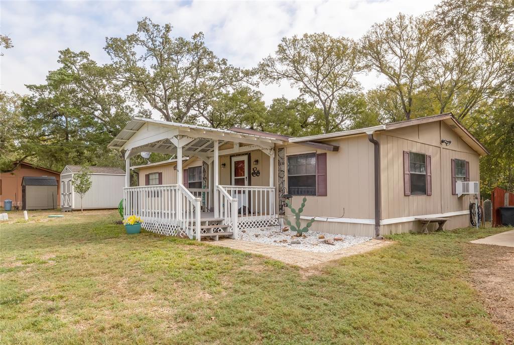 If you desire a peaceful place to live, where you can sit and listen to the birds sing or watch the deer play, then this is the place for you! The subdivision offers 5 ponds to go fishing and several parks. The Fire Department and Post Office are close by. This well maintained double wide has 1344 sf. sits on 2.043 acres. It has covered front and back porches. New HVAC in 2019, New roof in 2016, New Water heater in 2018, New Microwave in 2022. 3 Septic tanks that were cleaned out a year ago. Water Well was dug to 150 feet (was 85) and a New Pump in 2021. The Well has 1 Settling tank and 1 Bladder tank. Community water will be installed to this home (see documents) with no cost to the owner. Outside there are 3 buildings; 16X16 storage/barn, 8X12 storage/shed also a pump house/storage building.  A 22X24 concrete slab has been poured for a carport or garage. There is plenty of room for a 4H or Fair project, if needed.
