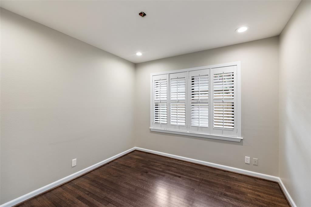 Bedroom # 2 with wood floors, recessed lights and plantation shutters.