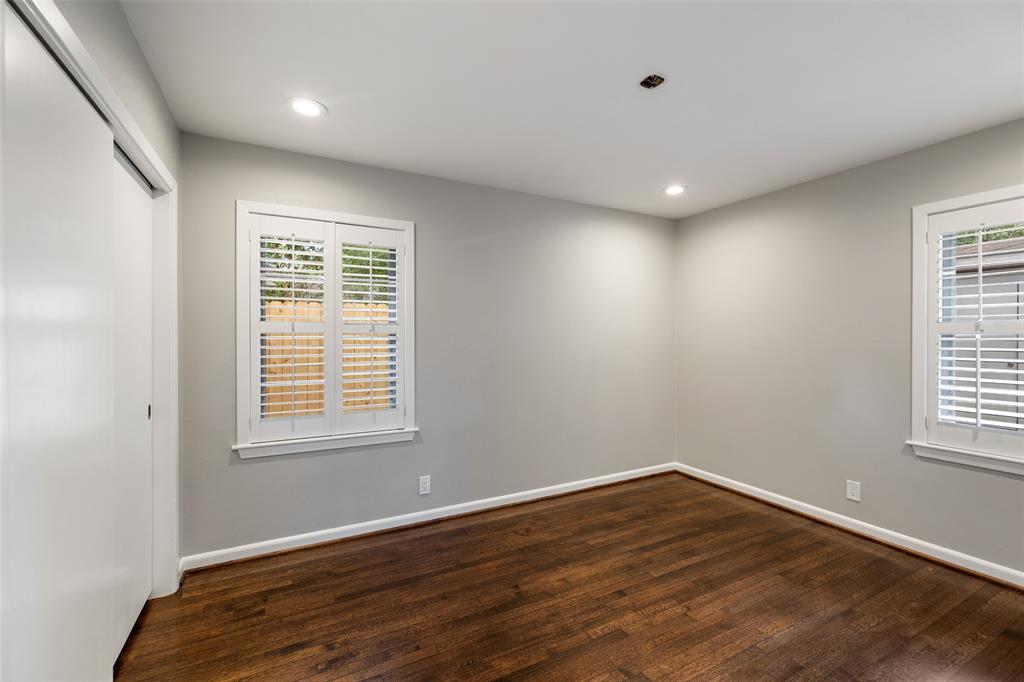 Bedroom # 3 features wood floors, recessed lights and plantation shutters.