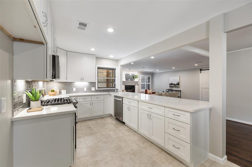 The family chef will love the updated kitchen that features new cabinets, quartz counter tops, under cabinet lighting and stainless steel appliances.