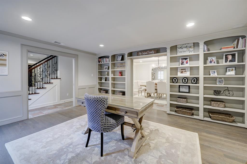The architectural built-in bookshelves and chair rail molding complete the look of this library/study/second living room.