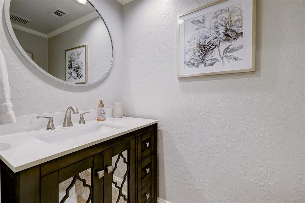 Of course on the first floor is a guest half bath with a recently updated vanity, located discreetly in the hallway.