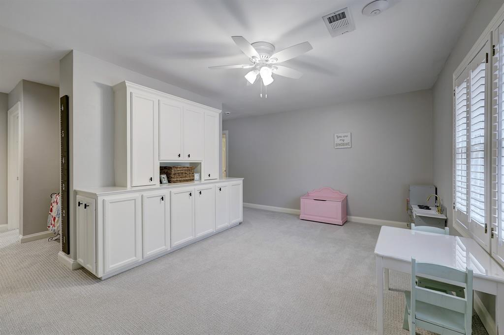 Between the first two bedrooms and the next two is another living area perfect as a play room, though could certainly also function as an office, media room or exercise space.
