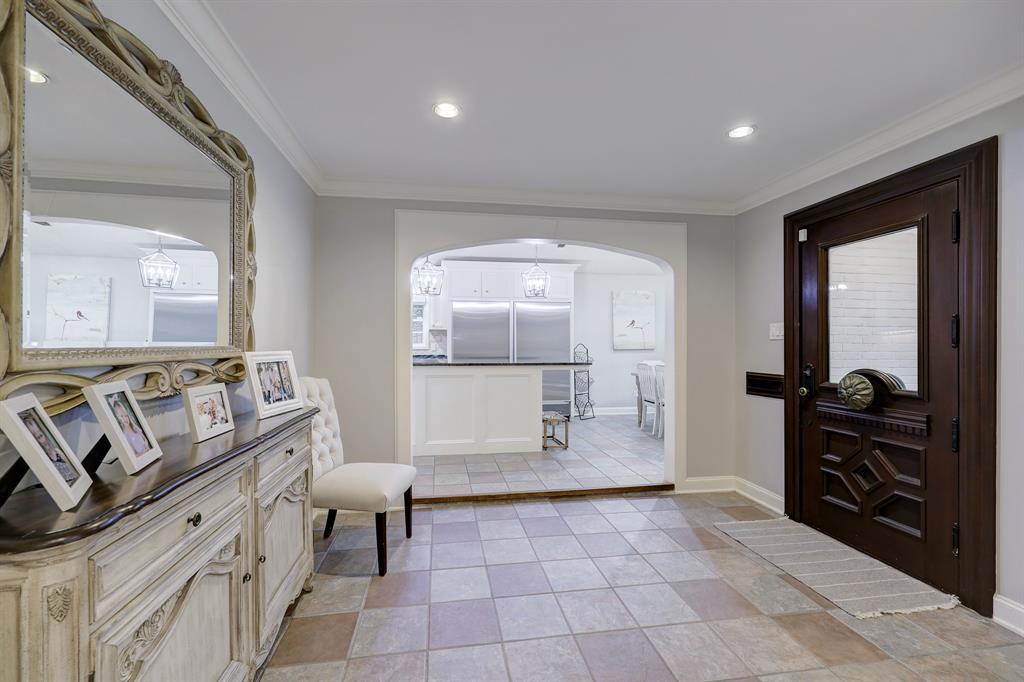 A generous tiled entry foyer sits between the kitchen and family room.