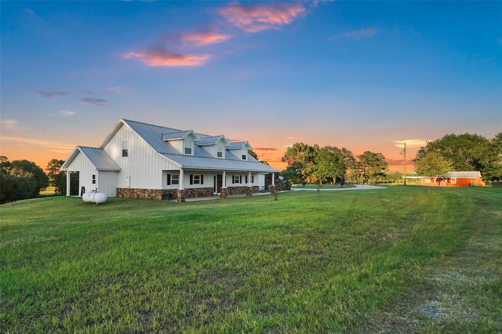 Looking for a farm, weekend getaway or hunting property? This 66+ ac parcel may be the solution! The modern farmhouse sits high/dry overlooking pastures, 3 ponds, seasonal creek & mixed woods in a quiet country setting. Note the hardwood floors/Austin stone fireplace. The primary offers private entry to back porch overlooking the rolling acreage; ensuite has nicely appointed shower, dual sinks & enormous walk-in. The kitchen has leather finish granite, butcher block island, double oven gas range, stainless appliances, farmhouse sink, beechwood cabinetry. Fantastic utility/mud room has coat rack, half bath, utility sink, huge pantry & storage. Features: Generac 22 KW generator, metal roof, spray foam insulation, 50'x50' hay barn, chicken coop, garden w/water, gates, 13'x16' shed, 50'x40' equipment shed, 36'x36' metal barn, cross-fencing, propane tank, tankless water heater & 2015/16 AC's. Guest house: 2 bd/1 ba/kitchen/living/metal roof. Low tax rate. 36 miles to Huntsville. Visit today
