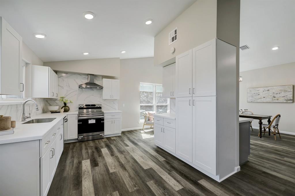 A look at the (literally) all new kitchen with stellar design choices like this luxury vinyl plank flooring.