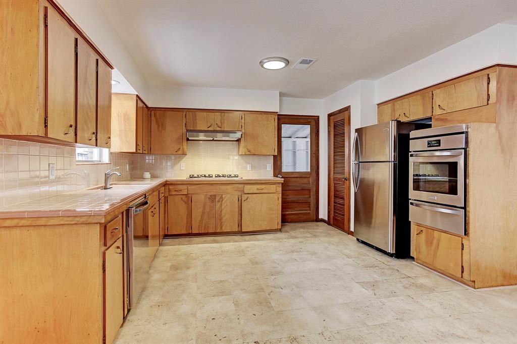 This space could readily accommodate a moveable island, and the appliances have been upgraded in recent years to stainless steel, including a dishwasher.