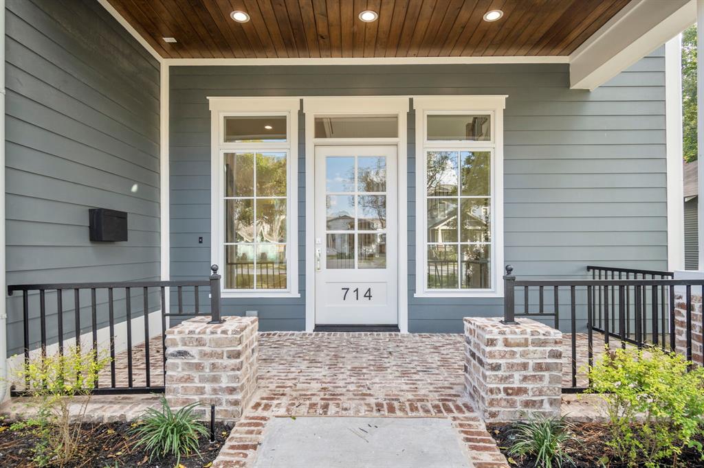 As you approach the front door of this 4,293 square foot home, notice the stained beadboard ceiling above the charming brick-paved porch defined by handsome wrought iron and brick porch pillars.