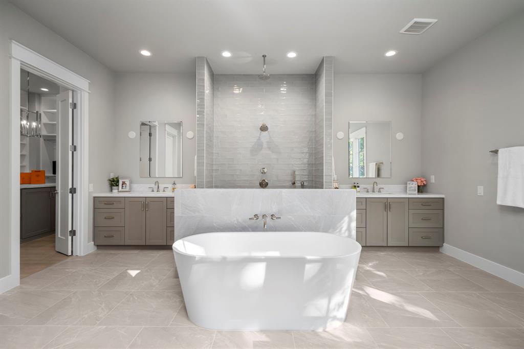 It isn't often that you find a master bath that measures 18' in width. Dual 6' vanities act as bookends in between the oversized, dual entry shower.