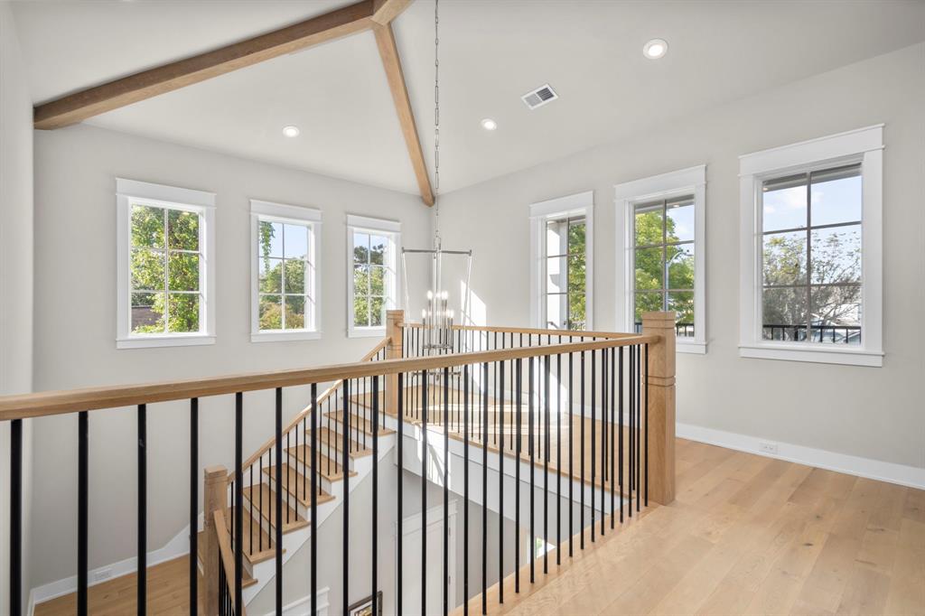 Subtle quality details are worth pointing out such as iron stair balusters drilled directly into the floor and designer newels with handsome linear accents. To the right of the windows, you will find the entrance to the upstairs game room.