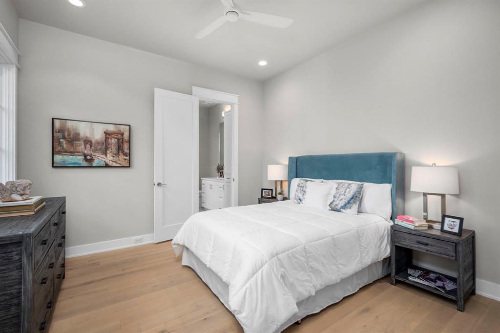 The middle bedroom has north facing windows. The bathroom with its walk-in shower is located to the left of the bed. Each of the secondary bedrooms has a Minka-Aire 52" ceiling fan.