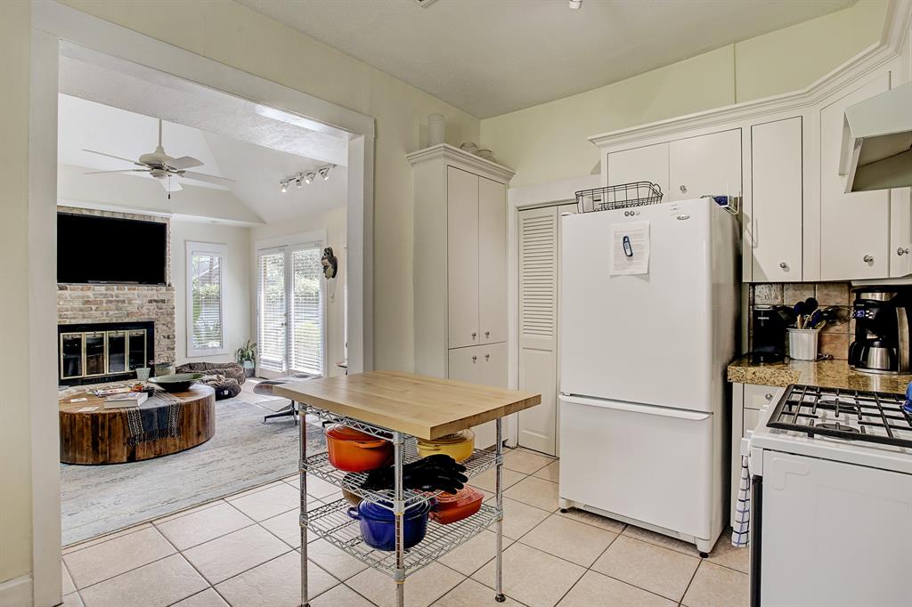 The louvered doors to the left of the refrigerator conceal the washer and dryer.