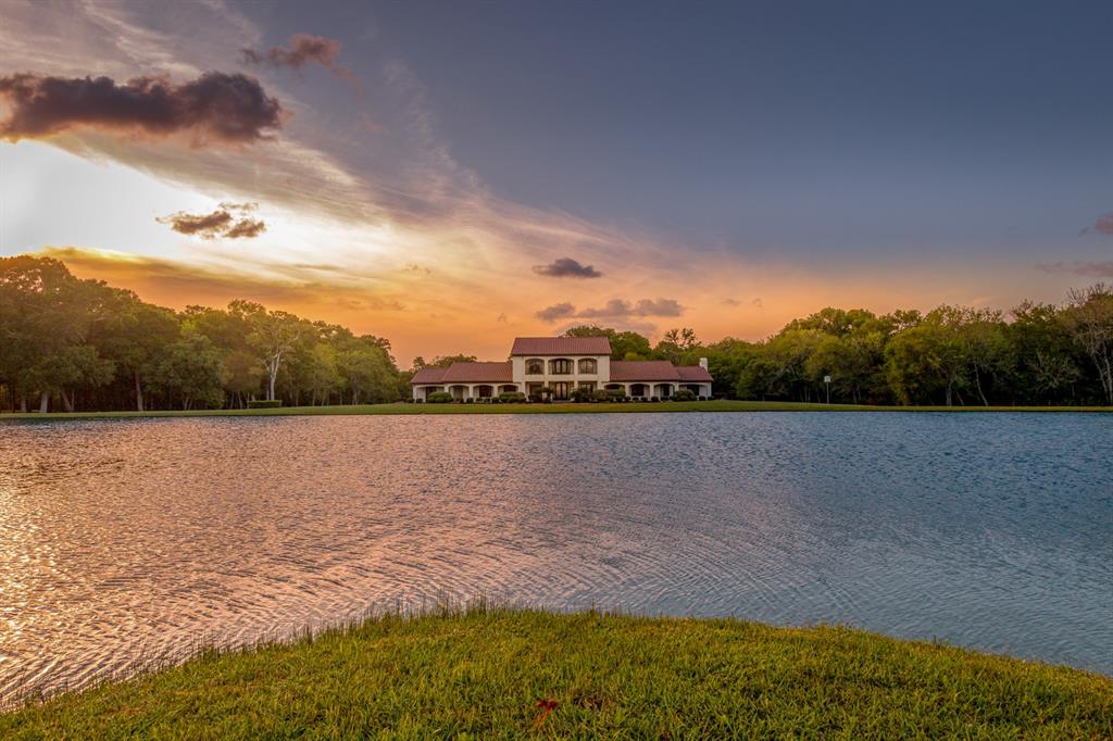 This stunning 51± acre gated estate with private 3+/- acre lake is located less than an hour from Houston. The property is unrestricted allowing for numerous commercial opportunities as an event venue, corporate retreat location, and more! The stunning custom main home boasts beautiful interior finishes with 30± foot soaring ceilings & knotty alder finishes. A private elevator leads to the second level primary retreat with terraces overlooking both the lake and open pasture for wildlife viewing. In addition there is a 3 bedroom guest house with loft space, kitchen, & living area. Lakeside there is a covered cantina with commercial amenities for outdoor entertaining and relaxing. The property also features two covered RV or boat hookups with electricity and storage space. With nature trails throughout this is a unique opportunity to own a private ranch with a resort-like feel, that has endless recreational possibilities and great access to all nearby amenities.