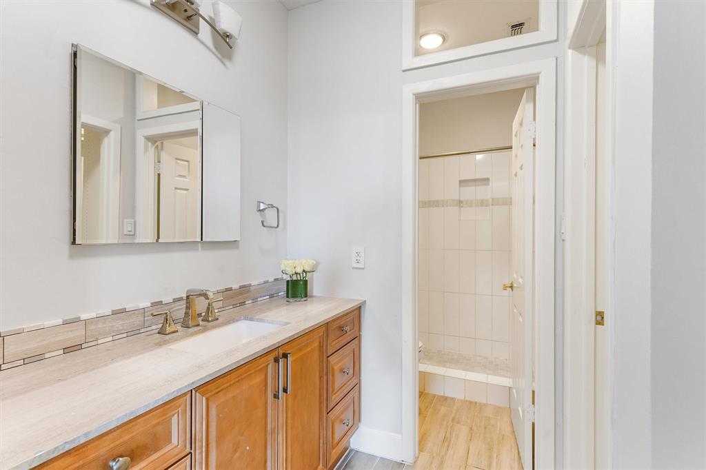 Renovated bathroom boasts granite countertops and soft closing cabinets and drawers.