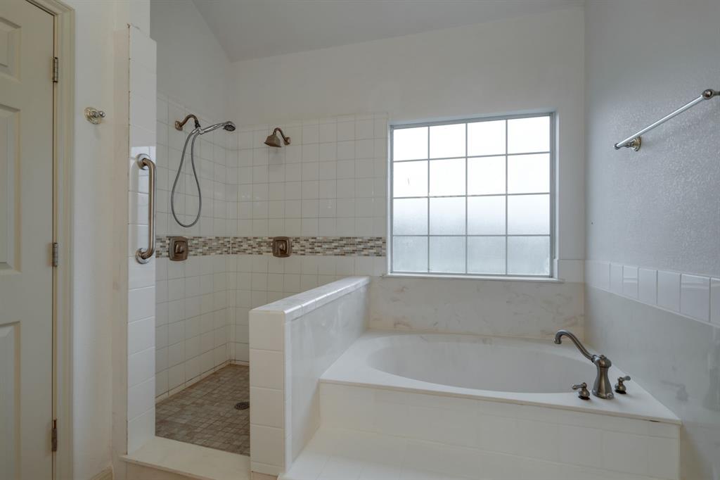 Primary Bathroom with a garden tub and a spacious walk-in shower.