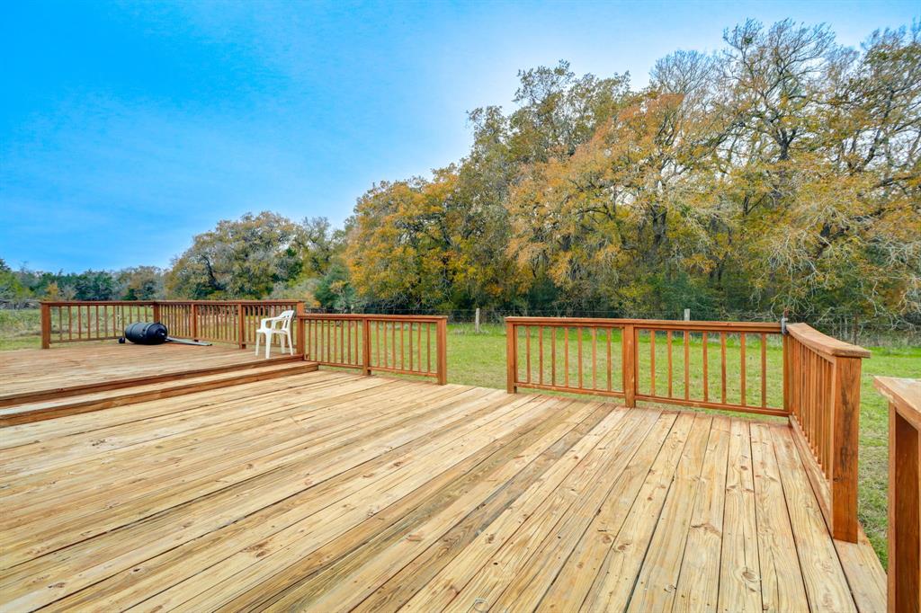 Expansive deck overlooking the wooded wildlife area with creek frontage.