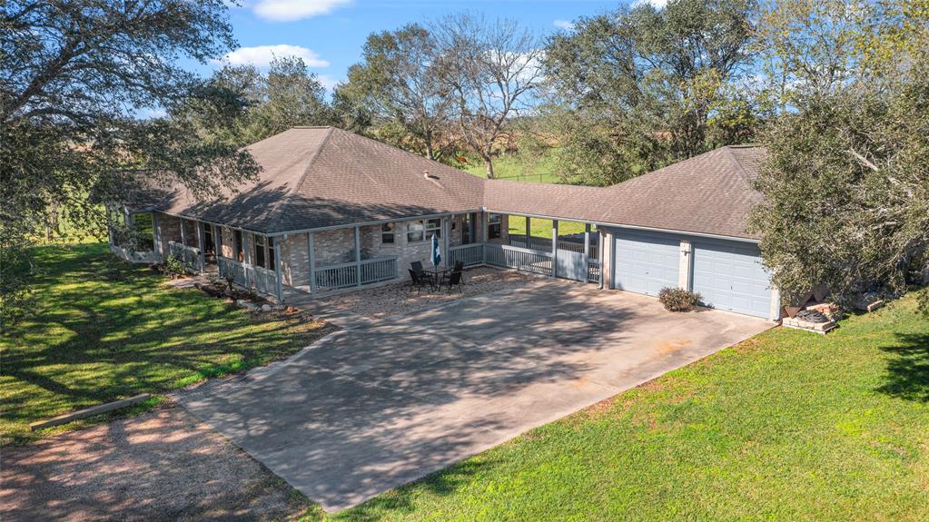 "The Barn" is a 44+ Acre family Ranch located less than 35 minutes from the Houston metro area w/endless opportunities & appeal from Equestrian enthusiasts, Cattle Ranchers, to Commercial Investors. The main home is nestled amongst beautiful mature oak trees & surrounded by improved green pastures that are fenced & crossed fenced. The extended front porch provides a welcoming entry into the fabulous farmhouse inspired home w/interior features: wood burning fireplace, spacious living room w/wood floors, beautiful Vestage decorative tile in the kitchen & dining, granite counters, custom cabinets, stainless appliances, & breakfast room overlooking the acreage in back. The exterior is excellent for horses, cows, chickens, or any animal you desire; The property is unrestricted! "The Barn" is currently being used as a Wedding Venue however, the building is an open canvas allowing for a conversion of an equestrian barn, classic car shop, corporate event venue, Home Business, etc. Must See!