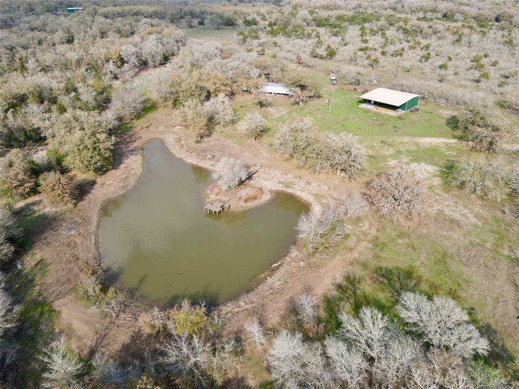 Great Location - minutes from IH 10 and Hwy 90 just east of downtown Waelder. This 69 acres has 2 great ponds, water well, clean 3 BR/2BH Mobile home 1216 sq ft, septic system and Muellar metal barn with concrete floor built in 2011 with electric and water, 1,500 sq ft enclosed and an additional 1000 sq ft covered. Pack your bags, hunt, fish, ride the trails and take in some country relaxing fun. Enjoy this property immediately or build your own weekend or permanent residence. There are two ponds which recently have had work to dress them up. The property holds an agriculture exemption and has boundary and cross fencing, pens, misc. metal and wood structures and a windmill. The working water well serves the house and barn and is 785 deep with a 6” casing pipe  and a 4” pump per best of the sellers knowledge. There is a water line from windmill to the large tank and a water line from the main well to the smaller pond. Wildlife includes deer, hogs, dove, and turkey.