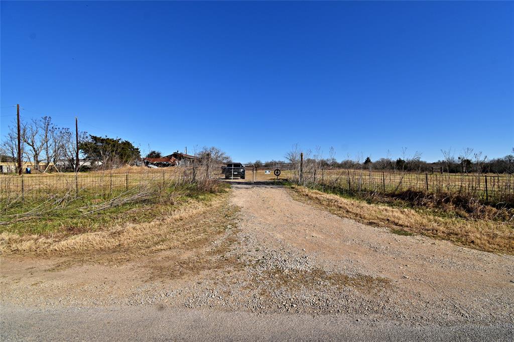 Over 60 acres of unrestricted land in Luling! This property has endless potential with mature trees towards the end of the property, build your own ranch and bring your animals! The home will convey with the right offer. This property is being sold AS-IS. Mineral rights do not convey. Schedule your showing today!