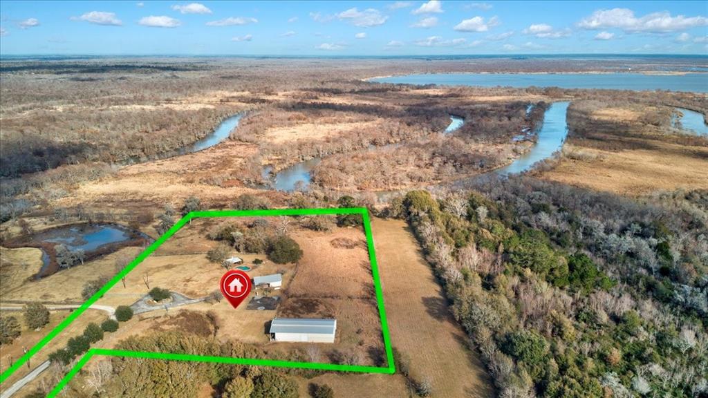 Soo Many Possibilities!  This unrestricted property is beautiful and waiting for you and your ideas.  There is a barn/shop, approx. 2,868 sq/ft,  to use as a barn, storage for all your toys, work shop, etc....  Stay in the 500+ sq/ft  pool house while you build your dream home or use it as a get away haven for rest & relaxation.  Bring your RV's and come and go as you please.  There is a pool for relaxing and a covered area with a fireplace for more relaxing! The covered area at the pool  can be used  sit and enjoy nature, watch the kids while they swim, watch your horses as they graze and so much more.  There are so many possibilities for this property!    Come look and see what your future  looks like here.