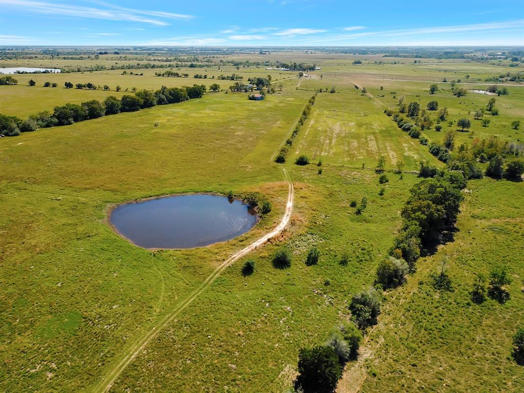 This is a 66.8 acre tract + or-  of beautiful rolling pastures with a large pond fenced and cross fenced native grasses agg exempt located on Bernardo road Cat Spring just a 2.5 mile  from I-10 access this property has to be sold with the adjoining listing MLS 137772167 a 4 acre track with a 3 bedroom one bath home built in 1948 they are priced separately but sold together and in an estate. survey will be complete by January 31st 2023