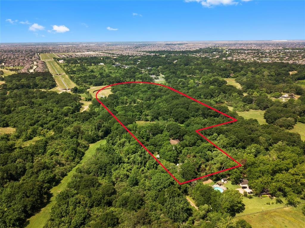 Developers or owner occupants are welcomed to this completely private piece of land tucked away from Westheimer Parkway.  Heavily wooded on approximately 17 acres of unrestricted sprawling land filled with fruit trees & serenity. Peaceful views in the morning with all types of wildlife! Close to everything in Katy! Single family home located on the front of the property with 3 bedrooms 2 baths and over 3,000 square feet of space. Detached garage with nearly 3,000 square feet to be used as a barn, workshop or guest house. Enjoy private access to Buffalo Bayou and agricultural exemptions. In addition to all the utilities, this property includes 3 septic tanks and a water well. This property has many opportunities to include equestrian needs, farming, commercial development, or a custom home.