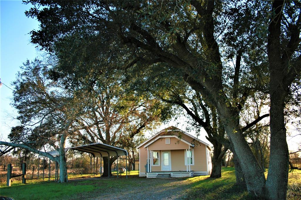 UNRESTRICTED 1-ACRE OUTSIDE THE CITY LIMITS!  APPROXIMATELY 162 FEET OF FM 3538 ROAD FRONTAGE.  MATURE Trees surround the charming 1940s farm house, carport and Tuff Shed storage building.  So many IMPROVEMENTS....new siding installed in 2018, energy efficient windows installed in 2016, new roof installed in 2018, freshly painted in neutral shades, fenced backyard, and separately fenced side yard that wraps behind the backyard.  COUNTRY location, with EASY ACCESS TO 1-10, WalMart Distribution Center, SIKA, BlenCor, and Hendrix.  Ideal location for a HOME and/or SMALL BUSINESS, investment property or rental in a rapidly developing area of subdivisions and industrial business.  NO DEED RESTRICTIONS! Get here before everyone else!