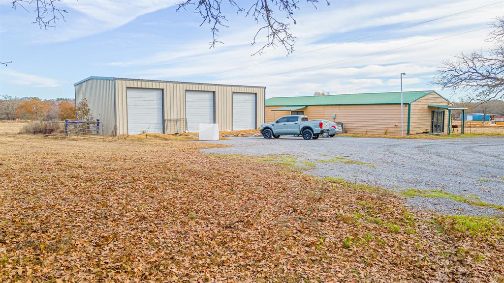 Perfect for the entrepreneur or hobbyist, this 3.17 acre unrestricted property is set up with two shops with room to expand a business or add a home in the back. Located just 40 minutes from Bryan off of FM 39, this unique property has so much to offer. The 30x70 shop was originally built as a sewing and quilting business and features two spacious rooms, each with their own entrance and separate half bath. Central air and heat is installed, walls are sheet rocked and floors are concrete for easy care. The 30x50 shop has three 10x12 overhead roll-up doors and a man door entrance on the side perfect for auto and machinery work. Clusters of trees offer shade around the buildings while the rest of the land is open pasture, fenced on two sides with a nice deep pond in the back. So many possibilities for developing this property. Come and see what you might do with it!