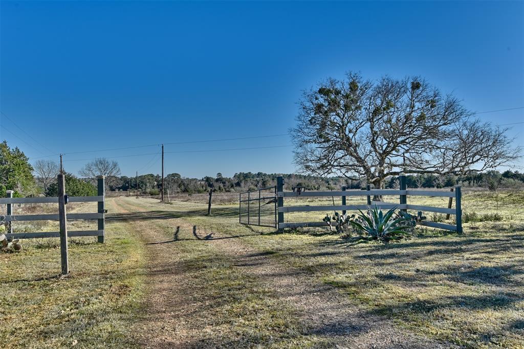 This 44.78 acres is composed of natural and native pasture as well as woodland with many large Live Oak trees. The property is managed for wildlife and has a wildlife tax exemption. The property features a 2.5 acre stocked pond which many species of ducks visit frequently. Minerals are available. 
The 3-Bedroom/3-Bath, two-story home was built on a choice location near the center of the property with total privacy in mind. The home features a spacious kitchen, and large covered porches on all sides awarding its owner outstanding views of sunrises and sunsets, as well as wonderful sightings of wildlife and the 2.5-acre lake. The main living area features an open concept floorplan with many windows.  The first story bedrooms have direct access to individual decks. The primary suite occupies the second story. 
A 30’x 40’ enclosed metal shop with a 20’x 30’ carport is located very near the home.