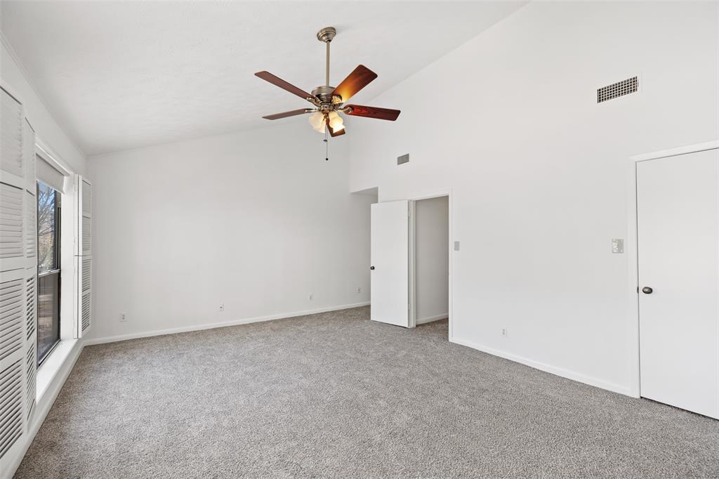 This large primary bedroom has vaulted ceilings and new carpet. It also includes a walk-in closet and en-suite.