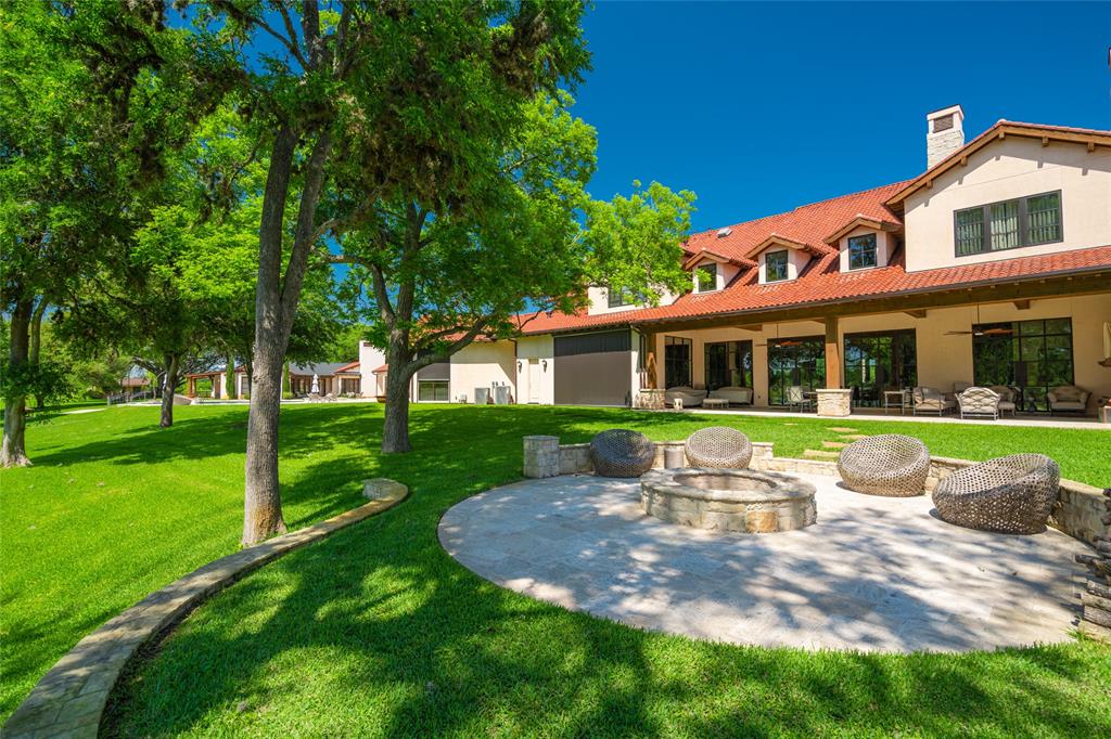 View from the Main House Backyard showing the great FIRE PIT with its stone surround, stone flooring and raised circular half wall.