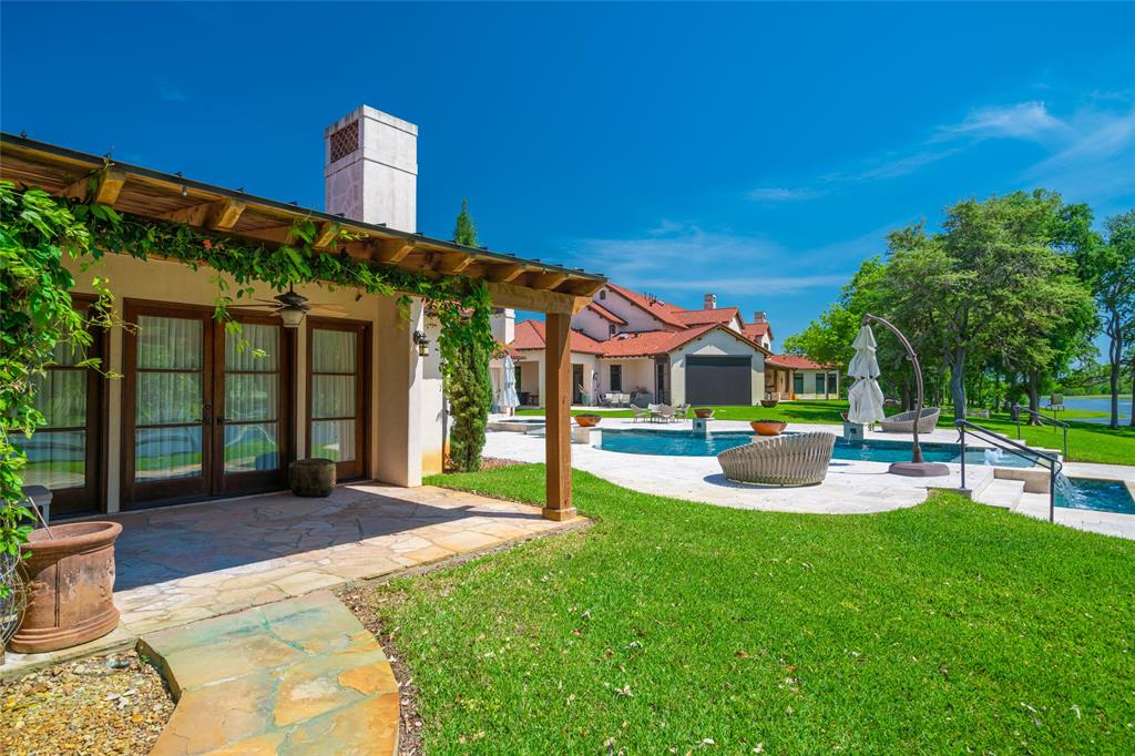 View from the three bedroom GUEST HOUSE with its charming covered patio, stone walkways and landscaped yard overlooking the Pool areas.