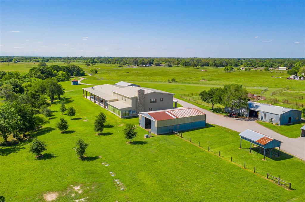 Aerial view of the BARNDOMINIUM with nearby storage buildings.