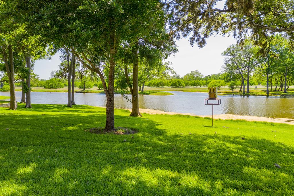 View from the Guest House and Main House looking across the grassed area to the lake beyond.