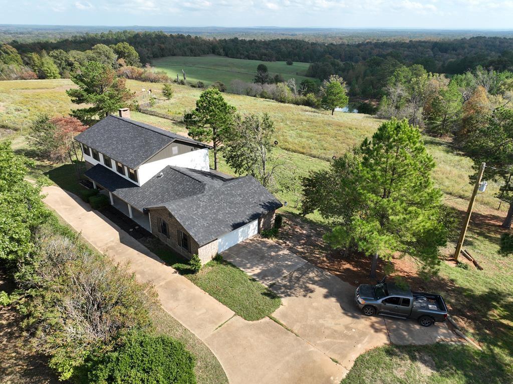 Calling all horse lovers! This lovely custom 4BD/2.5BA two-story brick & hardy sided home sits far back from the road nestled on 5.266 acres with breathtaking views of the East Texas Countryside. Kitchen features an abundance of cabinets, granite counters and a breakfast nook. Formal dining room! Living room has an expansive brick fireplace and built-in bar. Wood look tile downstairs and recessed lighting throughout. Updated bathrooms! All of the bedrooms are upstairs with large landing area. Great outdoor space with circle driveway and an extended deck perfect for entertaining. The land is fenced and ready for your horses or cattle. Don't Miss this horse lovers dream!