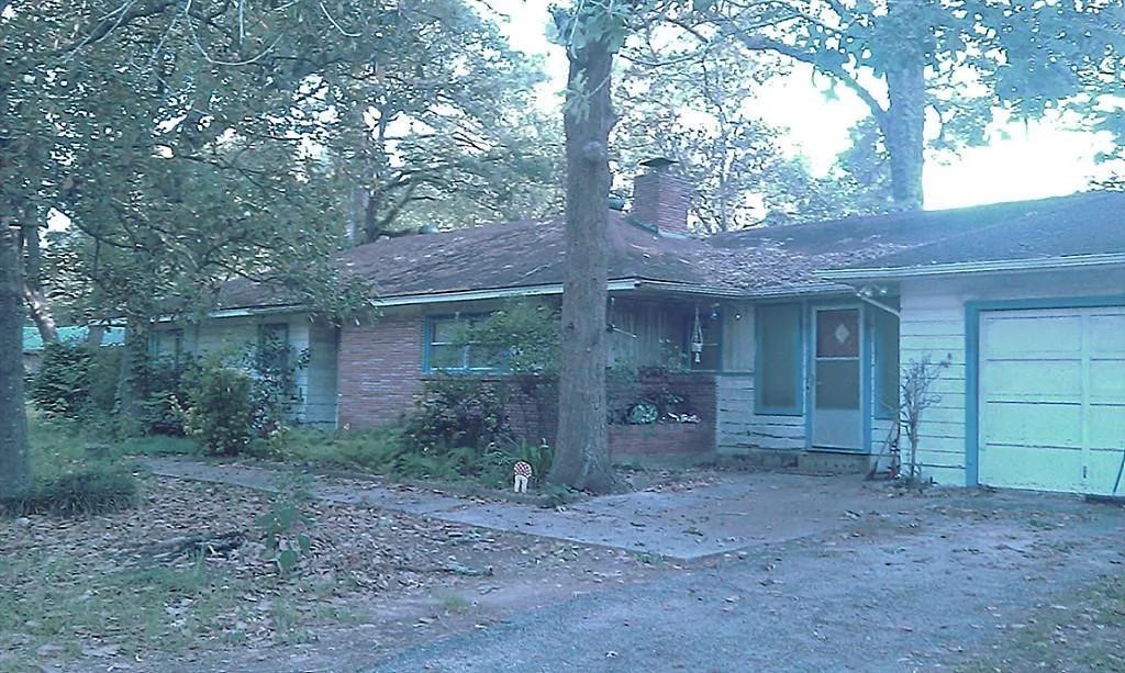 Great floor plan with hardwood floors throughout most of home. 3 bedroom, 1.5 bath. 2 living areas, formal dining. Wood burning fireplace. 2.77 unrestricted acres with beautiful hardwood trees, several large Magnolia trees.