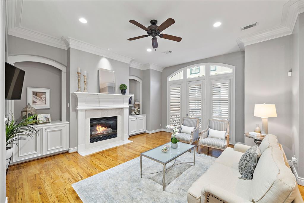 The spacious living room boasts engineered wood floors, high ceilings, and recessed lighting, creating a welcoming space with abundant natural light—perfect for large and intimate gatherings alike.