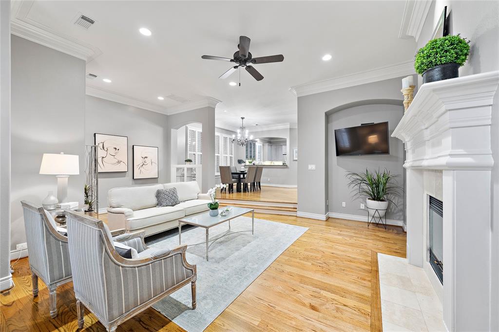 Designed for entertaining, the second floor showcases ample room for seating while leaving plenty of space to move around. The arched walls, crown moldings, and engineered wood floors add an elegant touch to the space.