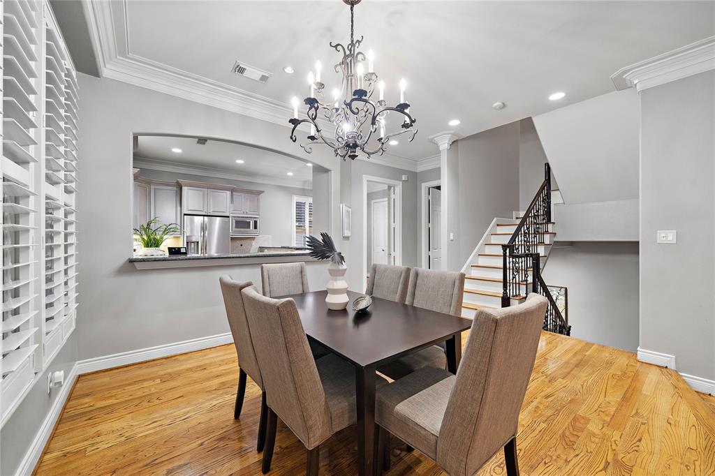 With its arched opening, the kitchen bar allows for seamless meal preparation and service in the adjacent dining area. The space also provides smooth access to the breakfast area and half-bath.