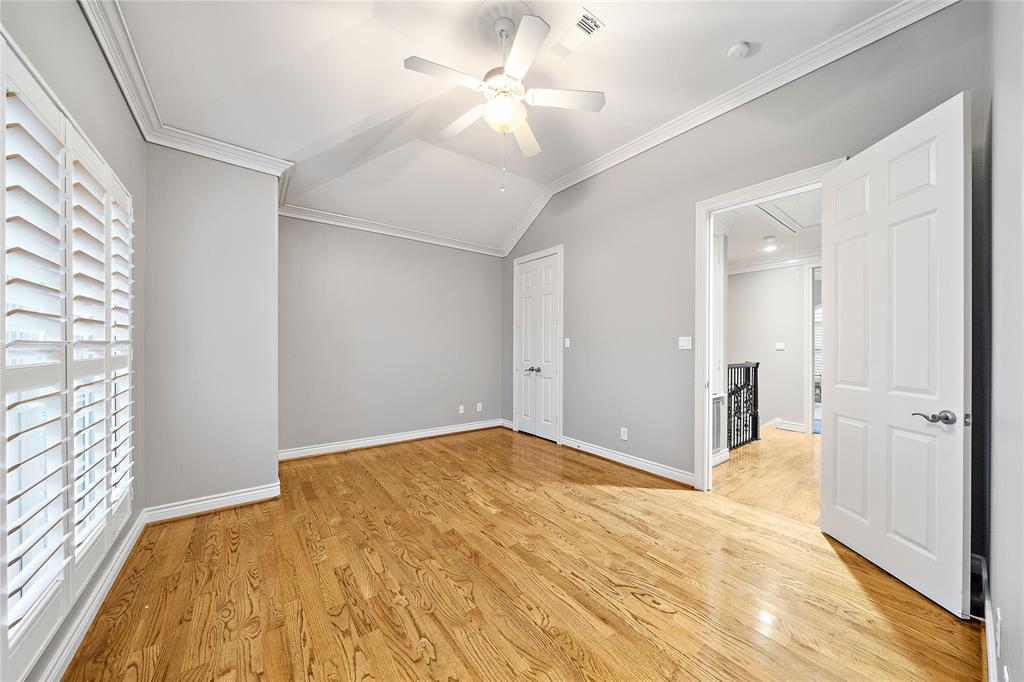 This secondary bedroom offers generous space and natural light. Delight in high ceilings, large windows with plantation shutters, a large closet, and an ensuite bath.