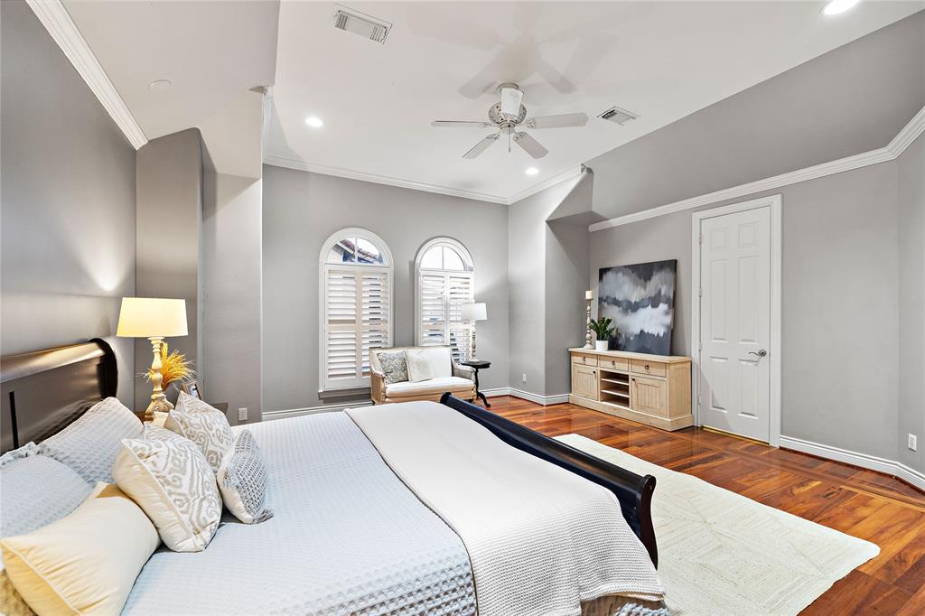 Comfort abounds in the expansive primary suite with ample space for a seating area and hardwood floors that add a classic touch and warmth to the room.