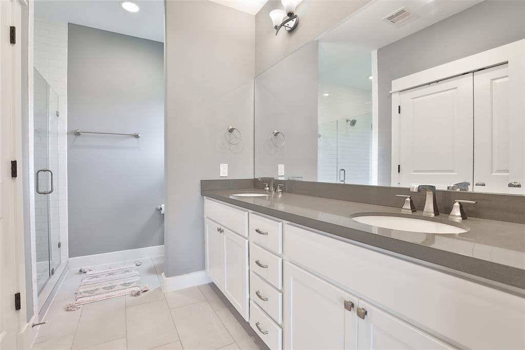 Primary en-suite bathroom with double sinks.