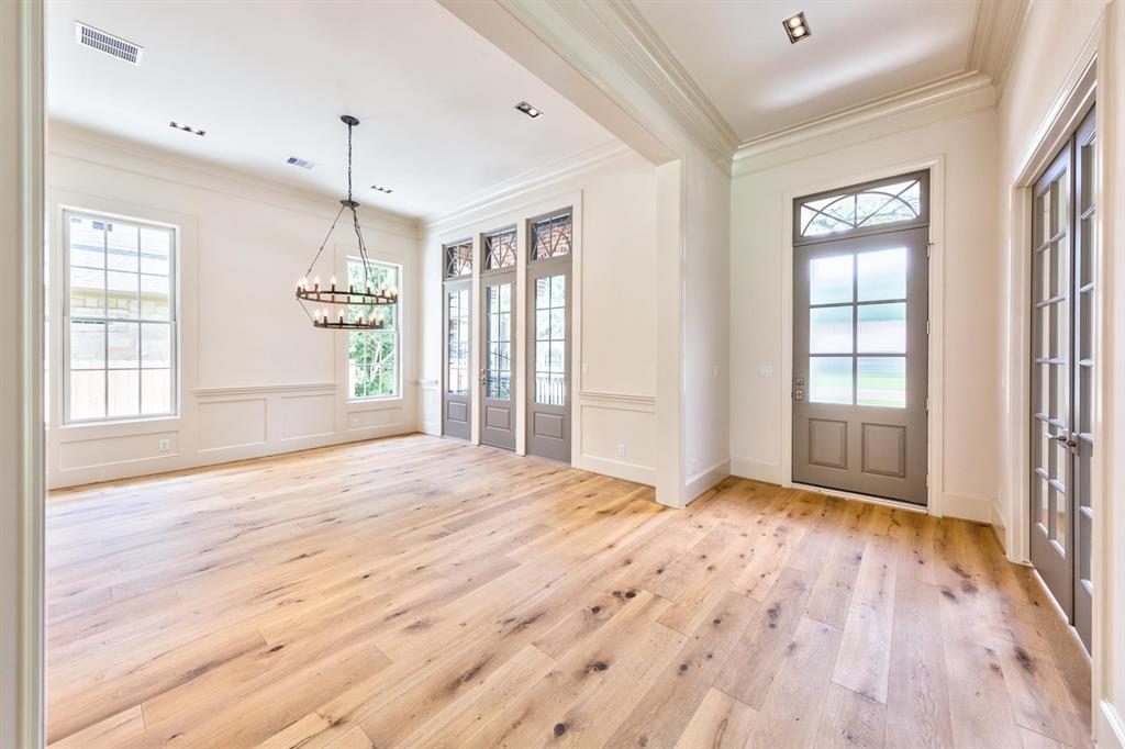 Floor to ceiling windows and beautiful trim that wrap the first floor impart timeless luxury in this previously sold home featuring a welcoming foyer centered on an impressive dining room and office with beautiful decorative paneling and built ins.
