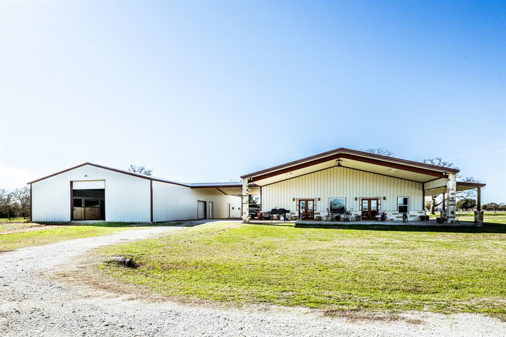 Looking for the perfect horse property, you have just found it!  This 32+acre tract has been cross fenced with 3 turn out pastures, net wiring around the entire property, five 12x14 horse stalls, an area for hay and tack, along with a 30x42 shop on a slab.  The metal building is 1,260 sq ft and the horse barn is 2,520 sq ft.  There is as 1,018 sq ft breezeway/carport between the barn dominium and the horse barn/shop.  As you enter the barn dominium through the backdoor you have a mudroom/utility/bathroom complete with a huge walk-in shower.  The home is a showcase for open concept in the living, dining and kitchen area.  Sit and enjoy cold evenings in front of the gas burning fireplace.  Both bedrooms are exceptionally large.  The master bedroom has two large walk-in closets.   The master bathroom comes with a shower and a soaking tub.  This property is approximately 30 miles to Huntsville, 40 miles to College Station, and 100 miles to Houston.  Horse owners this is your paradise!!