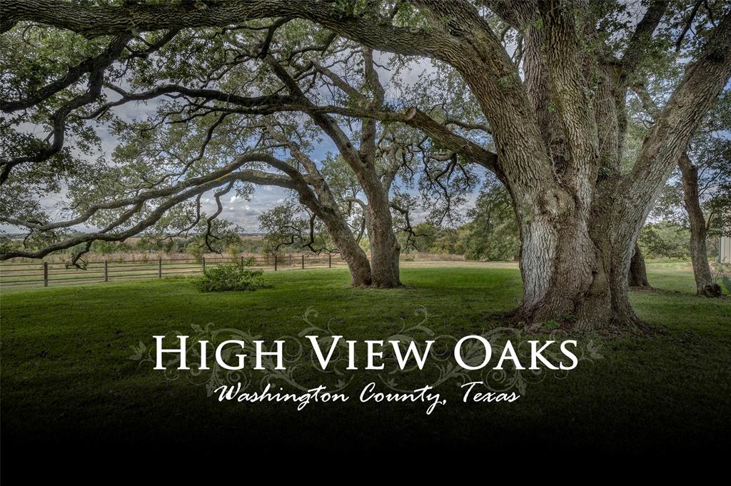 Approx. 31.333 acres featuring a high hill with long distance views of the rolling countryside. There is a large pond and groves of majestic Live Oak trees surround the custom home. Improvements include home with 3 bedrooms, 3 full and 1 half bathrooms, open kitchen and living area, bonus gameroom/office, flexroom, large back porch with outdoor kitchen and deck and 3 car carport with storage. Just past the deck is an inviting fire-pit area perfect for taking in the evening sunsets. Other improvements include: Metal multi-use barn with workout room, storage area on second level and equipment area – could also be used for woodshop or horse barn; Cabin with one room and bath overlooking the lake; RV Cabana with RV electric and septic hook-up, living area and bathroom; Shed with paddocks. There is a garden area, fruit trees and native prairie grasses have been re-established on a portion of the property. Paved road frontage with easy and quick access to Brenham and Bryan/College Station.