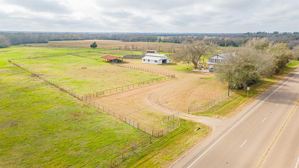 The perfect ranch has officially been listed! As you enter the gate you will be welcomed by 30 acres and an amazing 2 story stone home that consists of 3 bed and 2 baths among other features. Parking your car in the spacious 3 car garage you will want to walk upstairs to the living area where you will be greeted by a cozy living room and warm stone fire place! Upstairs you will find 2 bedrooms and 1 bathroom. This home will also boast its kitchen features by displaying cabinets and beautiful countertops, making the appliances stand out! To complete the upstairs tour, the unique sunroom allows you to have a view of the ranch with great wrap around windows! Downstairs offers an extra room and bathroom. You will also want to tour the spacious barn that has 5 stables, a tack room, and wash station to bring your equestrian dreams to life! This ranch also offers loafing sheds and a round pen to train your horses! To conclude, the stocked pond and pasture will also satisfy your outdoor needs!