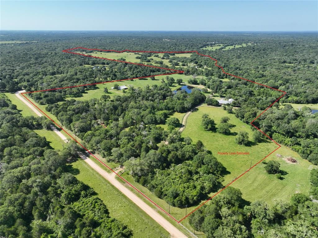 Property on Oak Rd in New Ulm, TX does not come on the market very often, and when it does, make sure you see it, it will be worth your while. 23611 Oak Rd is just that place, a premier family retreat with 166+ lush acres to explore and over 5000sf of living space to stay. This property has it all, with over 6600’ of San Bernard River frontage to discover, five ponds for fishing, woods with majestic Oaks for the wildlife, trails for traveling, and open pastures for roaming, the kids and grandkids will never want to leave. The spacious and inviting 5bed/6.5bath main house easily accommodates guests with the open-concept kitchen/living area, dining and breakfast rooms. The tastefully designed house has an office, craft room, sunroom, upstairs second living area, and generous front and back porches. Also on the property is a 1/1 guest cabin, utility barn with full bath, and various sheds. Come experience the beauty of this exquisite showpiece for yourself, just be prepared to stay awhile.